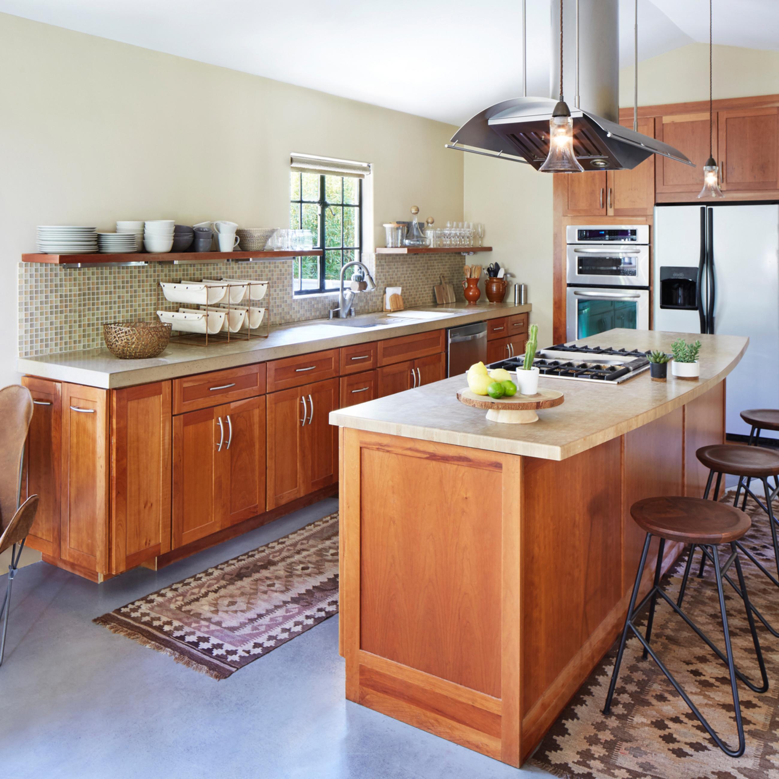 Kitchen remodel with custom island and hood with wood cabinetry.