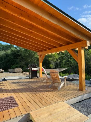 Large patio with overhanging roof.