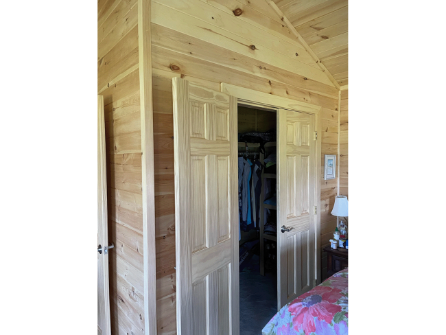 Bedroom closet with wood doors