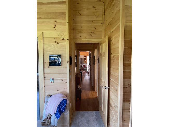 View of the hallway from the wood panel bedroom.