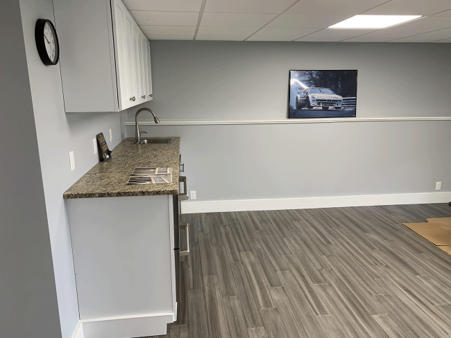 A side view of the kitchenette cabinets and countertop