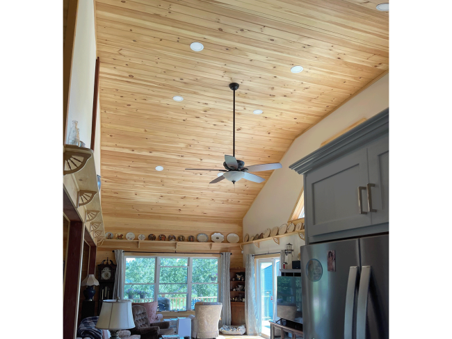 Wood shiplap ceiling with inset lighting in living room.