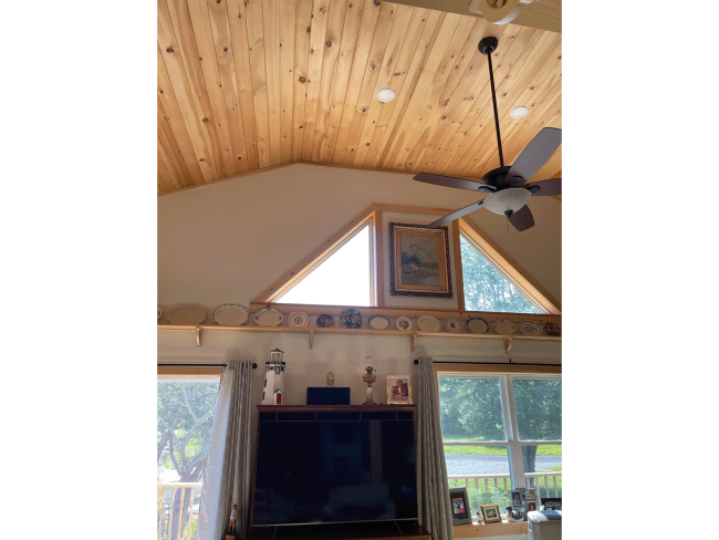 Two triangular windows with angular ceiling in wood shiplap