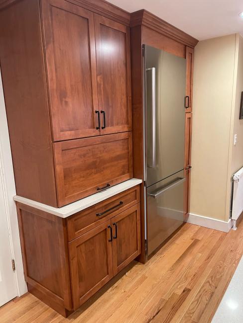 Custom kitchen cabinetry in a Maine home with new stainless appliances.