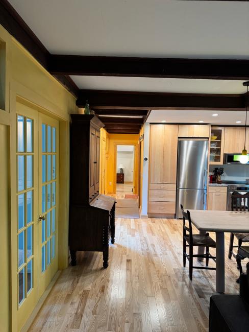 Kitchen remodel with new wood flooring to match and stainless steel appliances.