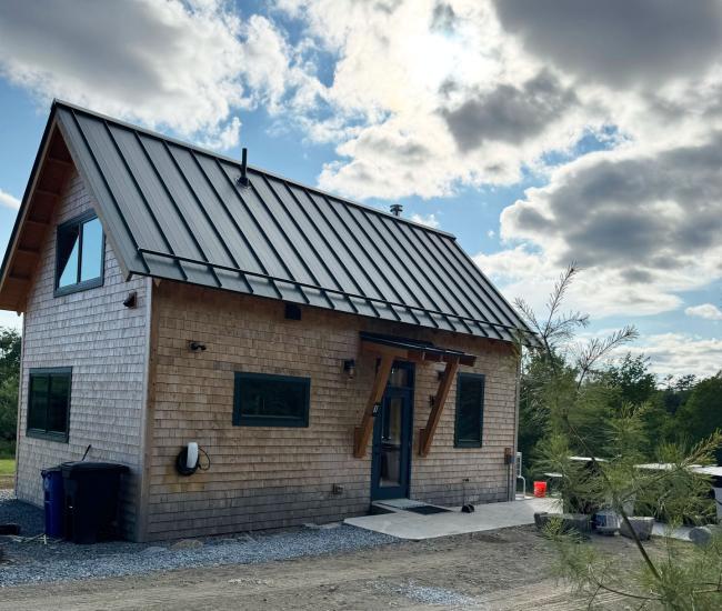 The Cherry wood cabin with metal roof.