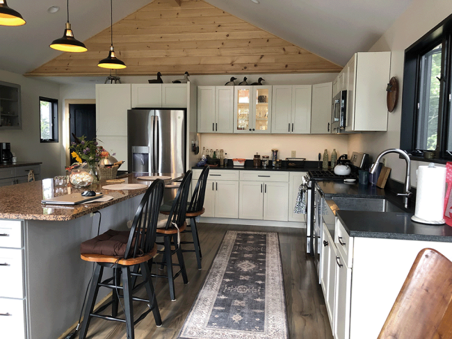 Newly built kitchen on the second floor with new countertops installed with kitchen island. New kitchen cabinets.