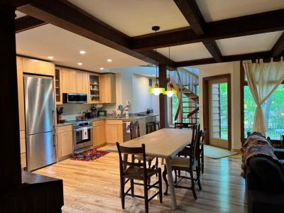 Kitchen remodel with new appliances and custom wood details. Open dining room